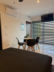 a bedroom with a table and chairs and a dining room at Loft with Private Terrace in Tepic