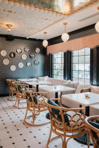 a restaurant with tables and chairs in a room at UNCOMMONER HOTEL by Reverie Boutique Collection in West Yarmouth