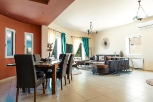 a dining room with a table and chairs at Selenophile Villa with heated pool in Monolithos