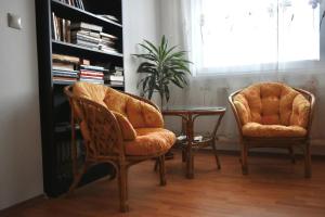 two chairs and a table in a room at Villa Paris in Piešťany