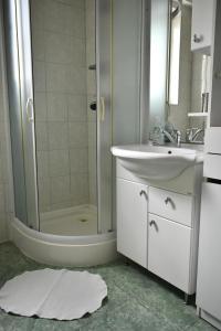 a bathroom with a shower and a sink and a tub at Villa Paris in Piešťany +11 photos
