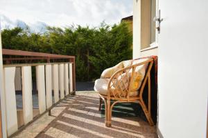 a chair sitting on the porch of a house at Villa Paris in Piešťany
