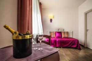 a room with a bottle of champagne and two wine glasses at Hotel O'scià in Lampedusa