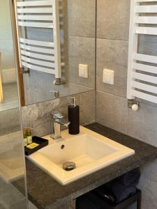 a bathroom with a sink and a mirror at Baltic Sea- domki z jacuzzi blisko natury in Władysławowo +35 photos
