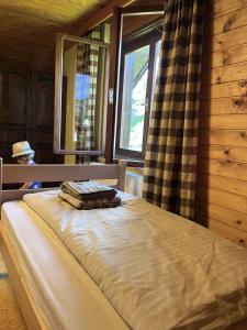 a bed in a room with a window at The Yugo House in Bohinj