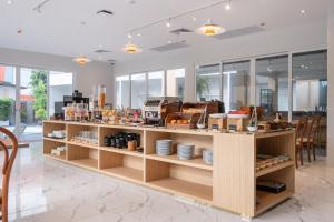 a store with wooden shelves with food on them at Manditel North Pattaya in North Pattaya