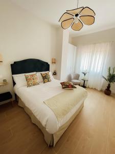 a bedroom with a large bed with a ceiling fan at Castros Homes in Santander