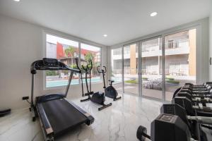 a gym with two exercise bikes in a room with windows at Manditel North Pattaya in North Pattaya +19 photos