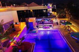 an overhead view of a swimming pool at night at Lemon hills hotel in Runda