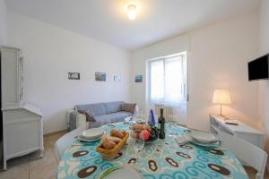a living room with a table and a couch at Casa Al Caprifoglio - Ispra Apartment 600m From Beach - Happy Rentals in Ispra +13 photos
