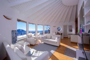 a living room with white furniture and large windows at The Perfect View in a Premeno Penthouse - Happy Rentals in Premeno