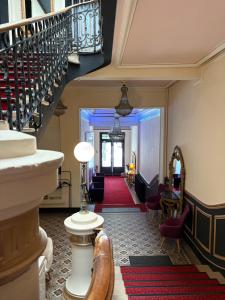 a hallway with a staircase and a living room at Salon Boyer in Épernay +43 photos