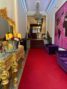 a room with a red carpet and stairs with a red rug at Salon Boyer in Épernay