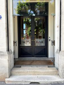 an entrance to a building with a black door at Salon Boyer in Épernay