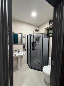 a bathroom with a shower and a toilet and a sink at Hotel DIAMOND - სასტუმრო დაიმონდ in Akhaltsikhe