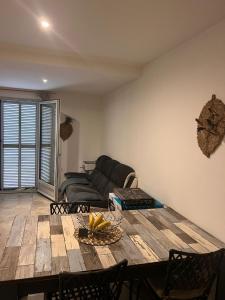 a living room with a table and a couch at F3 CENTRE de ST-FLORENT in Saint-Florent