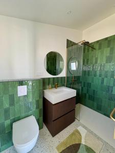 a bathroom with a toilet and a sink and a mirror at Doudou House in Saint-Denis-dʼOléron +21 photos