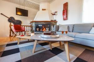 a living room with a couch and a fireplace at Olga in Mouresi