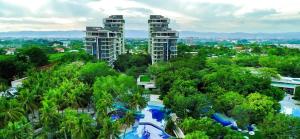 a view of a resort with trees and buildings at Go Q Tambuli Seaside Studio in Maribago