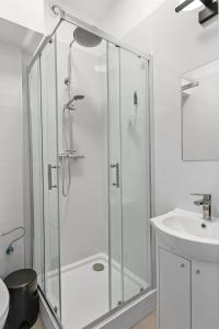 a bathroom with a shower and a sink at ZDZ Hostel Królewska 15 in Lublin