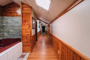 a hallway with wood paneling and a skylight at Riverside Motor Lodge - Pigeon Forge in Pigeon Forge +22 photos