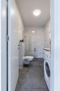 a white bathroom with a toilet and a washing machine at Cocco & Limone Boutique Residence in Sutivan +44 photos