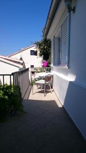 a patio with a table and chairs on a balcony at Apartments Mare in Hvar +2 photos