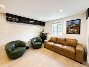 a living room with a couch and two chairs at The Royal Suite - Hot Tub - Free EV Chrger in Boischâtel