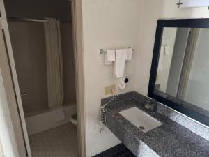 a bathroom with a sink and a mirror at Bonifay Inn in Bonifay +5 photos