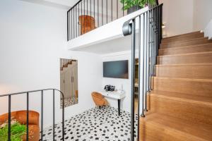 a hallway with a staircase and a desk in a house at Heritage Hotel Lucia in Dubrovnik