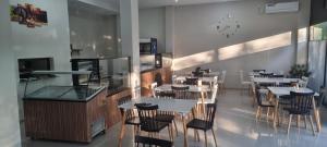 a restaurant with tables and chairs in a room at French Hotel in Kobuleti