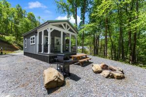 a small shed with a picnic table and a bench at Nantahala Ridge in Bryson City