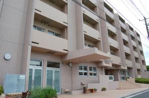 an apartment building with stairs in front of it at Refre Forum in Tokyo