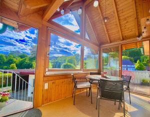a room with a table and chairs and a large window at Ferienwohnung Lea La Milan in Stockach