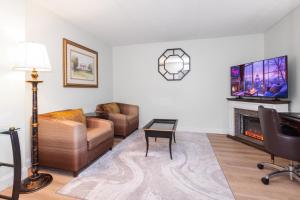 a living room with a couch and a fireplace at Metro Points Hotel Washington North in New Carrollton