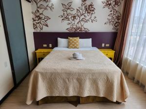 a bedroom with a large bed with a blanket at Park Place Hotel in Siguatepeque +26 photos