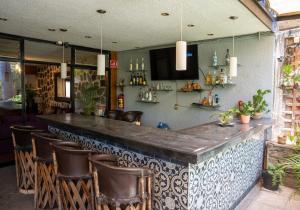 a bar with leather chairs and a counter in a restaurant at Toca Madera in Chapala