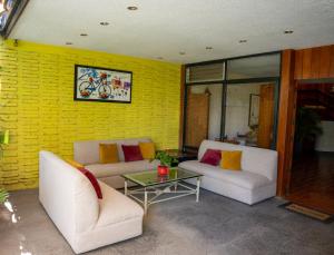 a living room with two couches and a table at Toca Madera in Chapala