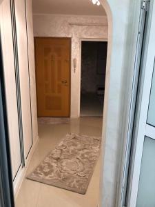 a hallway with a door with a rug in front of it at AmiraHome in Galaţi +1 photo