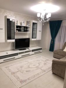 a living room with a flat screen tv and a couch at AmiraHome in Galaţi
