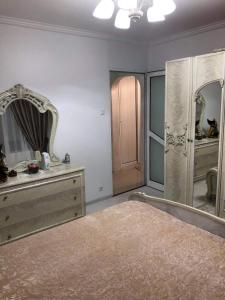 a bedroom with a bed and a large mirror at AmiraHome in Galaţi