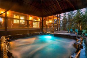 a swimming pool in the middle of a house at Smoky Mountain Cabin, Sleeps 12, 2 Kitchens & Hot Tub in Pigeon Forge