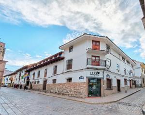a white building on the side of a street at Kantu hotel in Cusco