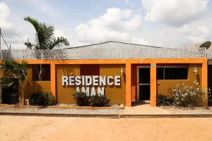 an orange building with the words resilience mmm on it at Résidences AMAN in Morofé