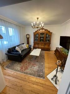 a living room with a couch and a table at Ferienwohnung in Barockstil in Lengerich