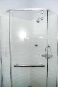 a shower with a glass door in a bathroom at Cote Cottage in Somerset West +17 photos