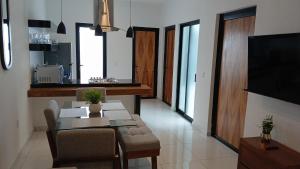 a living room with a dining table and a television at Orion department in Tepic