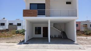 a white building with a staircase and a stair case at Orion department in Tepic
