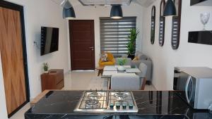 a kitchen and living room with a stove top at Orion department in Tepic