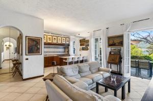 a living room with a couch and a table at Casa Donata by Gottschalk in Lierna